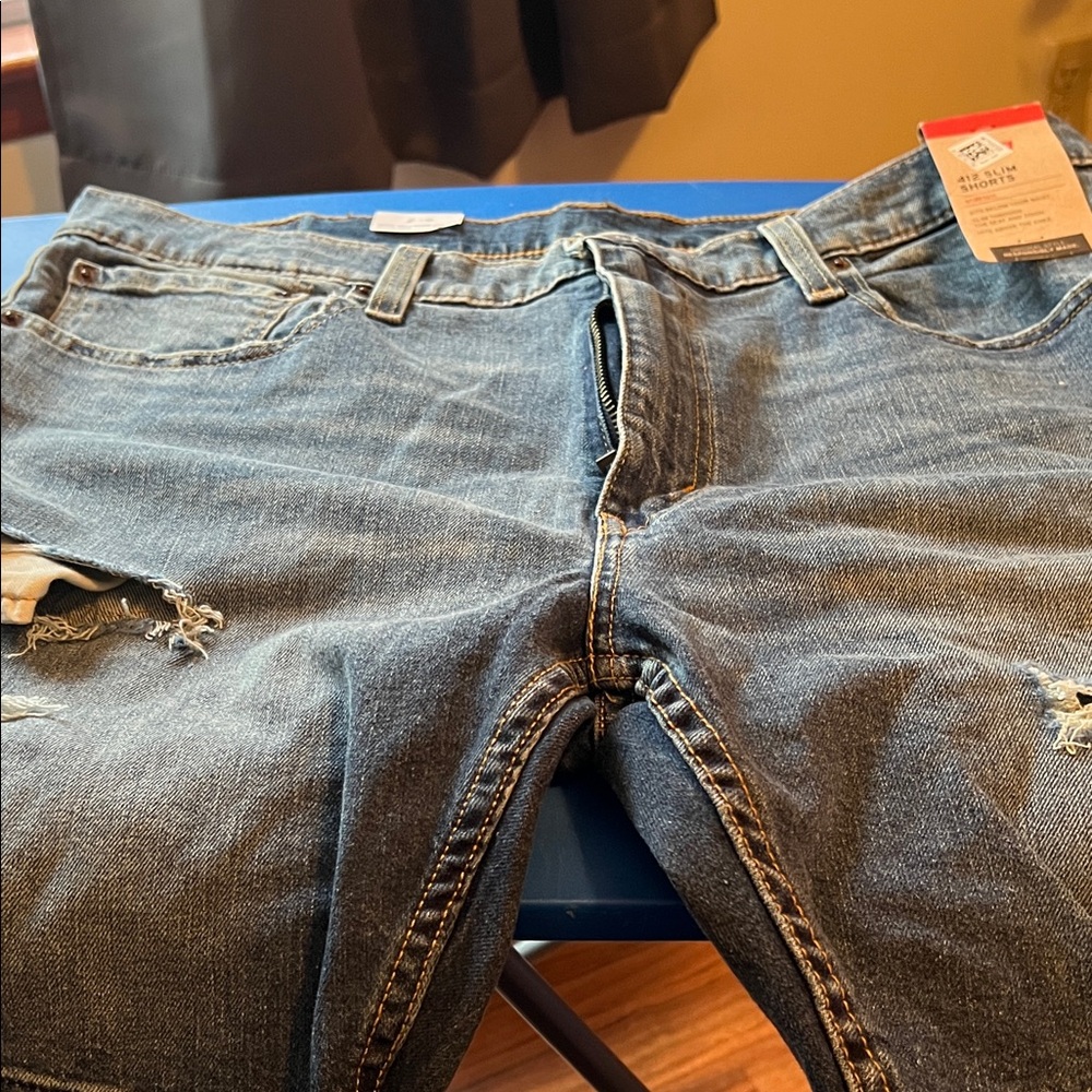 Men Levi’s distressed blue Jean shorts. Brand new with tags. Size 38
